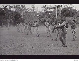 DONADABU, SOGERI VALLEY, NEW GUINEA. 1943-06-28. BREN GUNNERS OF "A" COMPANY, 9TH AUSTRALIAN INFANTRY BATTALION, FIRING FROM THE HIP WHILE ADVANCING ON THE TARGET, DURING A PRACTICE SHOOT