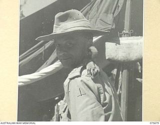 LAE, NEW GUINEA. 1944-09-08. CAPTAIN D.L. PROVMAN, ASSISTANT CAMP COMMANDANT, HEADQUARTERS, NEW GUINEA FORCE, SHOWING HIS NEW GUINEA FLYING SQUIRREL WHICH HE FOUND IN THE JUNGLE