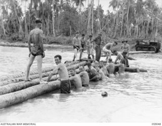 BUMI RIVER, NEW GUINEA. 1943-10-19. ENGINEERS OF THE 2/3RD AUSTRALIAN FIELD COMPANY, ROYAL AUSTRALIAN ENGINEERS CONSTRUCTING A NEW BRIDGE OVER THE RIVER TO REPLACE THE ONE WHICH WAS WASHED AWAY THE ..