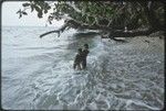 Children play in surf, on the east coast of Kiriwina