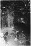 Keesing's children and others in pool of water, waterfall