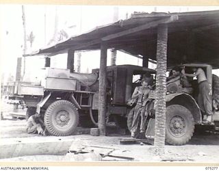 MADANG, NEW GUINEA. 1944-08-15. TROOPS OF NO.17 SECTION, GENERAL REPAIR WORKSHOPS, 165TH GENERAL TRANSPORT COMPANY WORKING ON A 3 TON WATER WAGGON AND A THREE TON FORD TRUCK. IDENTIFIED PERSONNEL ..