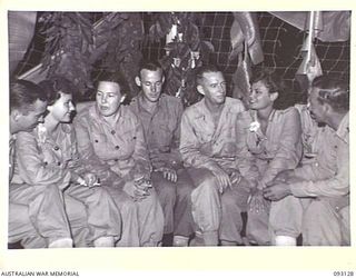 LAE AREA, NEW GUINEA, 1945-06-13. A GROUP WAITING FOR THE DANCING TO BEGIN AT A DINNER AND DANCE HELD BY NO. 2 OTHER RANKS' MESS, HQ FIRST ARMY