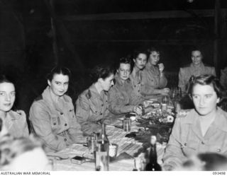 TOROKINA, BOUGAINVILLE. 1945-07-02. THE MAIN TABLE IN THE SISTERS' MESS, 2/1ST GENERAL HOSPITAL, DURING A FORMAL DINNER CELEBRATING THE 43RD ANNIVERSARY OF THE AUSTRALIAN ARMY NURSING SERVICE ..