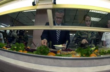 The Honorable Donald H. Rumsfeld, U.S. Secretary of Defense, assembles a salad at the Magellan Inn Dining facility during his visit to Andersen Air Force Base, Guam, during Exercise Cope North. (DoD photo by SENIOR AIRMAN Joshua Strang) (Released)