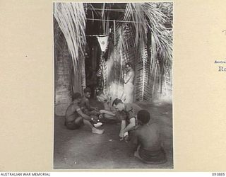 ULEBILUM RIDGE, YAMIL SECTOR, NEW GUINEA, 1945-07-08. CORPORAL E. BURGESS (1) AND SERGEANT P.J. BAIL (2), TREATING AUSTRALIAN NEW GUINEA ADMINISTRATION UNIT NATIVES AT 2/5 BATTALION REGIMENTAL AID ..