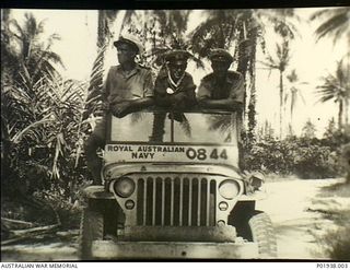 Bougainville, Solomon Islands. Three servicemen leaning over the windscreen of a RAN jeep numbered 0844. (Donor P White)