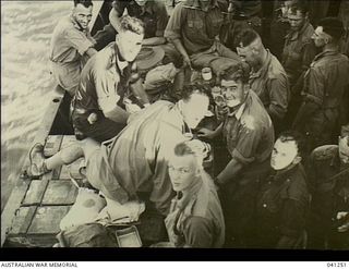 At Sea, off Papua. 1942-12-14. Members of the AIF relaxing after a meal aboard HMAS Broome before preparing for disembarkation at Buna