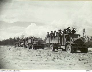 BOUGAINVILLE ISLAND. 1944-12-06. TRUCKS CARRYING MEMBERS OF THE 15TH INFANTRY BATTALION WAITING TO CROSS THE PONTOON BRIDGE BUILT BY TROOPS OF THE 5TH FIELD COMPANY, OVER THE REINI RIVER DURING ..