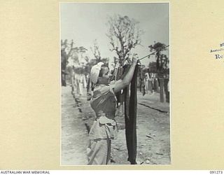 TOROKINA, BOUGAINVILLE. 1945-04-20. SISTER J.M. BRAY, AUSTRALIAN ARMY NURSING SERVICE, 2/1 GENERAL HOSPITAL, HANGING OUT THE DAILY WASHING