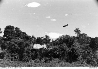 1942-12-08. NEW GUINEA. GONA. ALLIED PLANES SOAR IN AT LOW LEVEL TO MACHINE-GUN JAPANESE SNIPERS OUTSIDE GONA