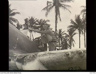 MOMOTE, LOS NEGROS ISLAND, ADMIRALTY ISLANDS. C. 1944-04. PILOT OFFICER BERT CALDWELL OF SYDNEY, NSW, AND NO 76 (KITTYHAWK) SQUADRON RAAF, CLIMBS INTO THE COCKPIT OF HIS AIRCRAFT. HE IS A FORMER ..