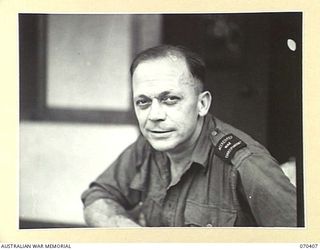 PORT MORESBY, PAPUA, NEW GUINEA, 1944-01-31. GEOFFREY F. NORTON, RADIO ANNOUNCER AT 9PA, THE AUSTRALIAN BROADCASTING COMMISSION'S NEW GUINEA REGIONAL STATION