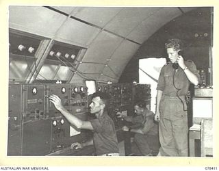 TOROKINA, BOUGAINVILLE ISLAND. 1945-01-18. A SECTION OF THE INTERIOR OF THE WIRELESS TRANSMITTING HUT OF "B" CORPS OF SIGNALS SHOWING THREE X 133 WIRELESS SETS - 300 WATT OUTPUT EACH. NX90230 ..