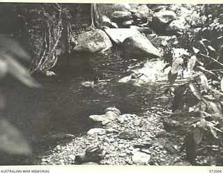 ILOLO - KOKODA, NEW GUINEA. 1944-04-30. MEMBERS OF CAMP 44, 18TH AUSTRALIAN LINES OF COMMUNICATION SIGNALS BATHING IN A NATURAL POOL NEAR THEIR UNIT