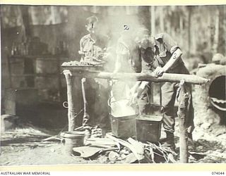 SIAR, NEW GUINEA. 1944-06-20. COOKS OF D COMPANY, 58/59TH INFANTRY BATTALION, PREPARING LUNCH IN THE UNIT COOKHOUSE. IDENTIFIED PERSONNEL ARE:- VX102551 SERGEANT W.H. BALL (1); VX140453 PRIVATE P. ..