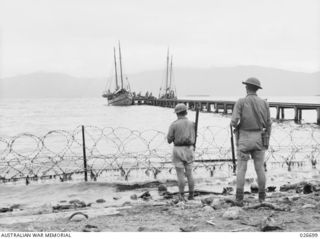 MILNE BAY, PAPUA. 1942-09. JETTY AT MILNE BAY FORMERLY OWNED BY LEVER BROTHERS PLANTATION, WHICH IS USED BY THE SMALLER CRAFT FOR UNLOADING