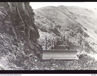 WAU-LABU ROAD, NEW GUINEA, 1945-12-13. A TD18 BULLDOZER OF 8 MECHANICAL EQUIPMENT COMPANY AT WORK ON THE SMAKE RIVER SECTION OF THE WAU-LABU ROAD AT THE 57.5 MILE MARK