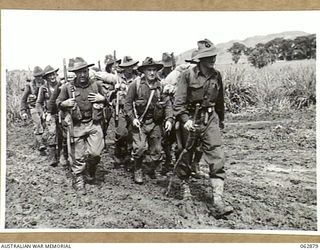 RAMU VALLEY, NEW GUINEA. 1944-01-15. A SECTION OF THE MORTAR PLATOON OF THE 57/60TH INFANTRY BATTALION LEAVING THE BATTALION HEADQUARTERS TO TAKE UP A FORWARD POSITION BEYOND KESAWAI. IDENTIFIED ..