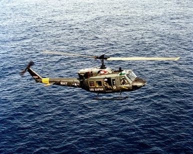 A right side view of UH-1N Iroquois helicopter assigned to the amphibious assault ship USS SAIPAN (LHA 2) in flight during the NATO Southern Region exercise DRAGON HAMMER '90