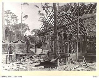 TOROKINA, BOUGAINVILLE. 1945-05-31. SAPPER MORRISON (1) AND SERGEANT BROTHERSON (2), MEMBERS OF 10 FIELD COMPANY ROYAL AUSTRALIAN ENGINEERS, WORKING ON THE CONSTRUCTION OF GLOUCESTER HOUSE AT ..