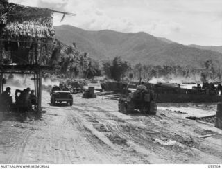 NASSAU BAY, NEW GUINEA. 1943-08-16. BEACH AT NASSAU BAY SHOWING TROOPS OF THE 542ND ENGINEERING BOAT AND SHORE REGIMENT, UNITED STATES FORCES, ENGAGED IN UNLOADING BARGE BEACHED DURING THE PREVIOUS ..