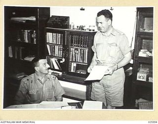 PORT MORESBY, PAPUA. 1942-07. MAJOR GENERAL B.M. MORRIS, GENERAL OFFICER COMMANDING NEW GUINEA FORCE (LEFT), IN HIS HEADQUARTERS WITH LIEUTENANT COLONEL E.B. SERISSIER, ASSISTANT ADJUTANT AND ..