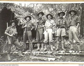 GOODVIEW, NEW GUINEA, 1943-08-03. AUSTRALIAN AND NEW GUINEA ADMINISTRATIVE UNIT (ANGAU) PERSONNEL ATTACHED TO THE 17TH INFANTRY BRIGADE. LEFT TO RIGHT:- NG2022 SERGEANT A. M. GRAHAM; PX102 WARRANT ..