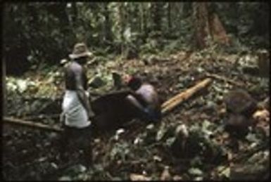 Men making petroglyph carving