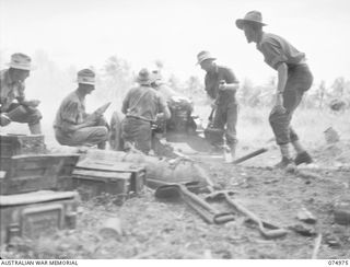 MILILAT, NEW GUINEA. 1944-07-26. TROOPS OF NO. 3 GUN CREW, "F" TROOP, 64TH BATTERY, 2/14TH FIELD REGIMENT, PREPARE TO RELOAD THEIR SHORT 25 POUNDERS DURING A RAPID FIRE EXERCISE. IDENTIFIED ..