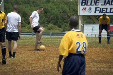 The US Navy (USN) Varsity Soccer team plays against the Russian Federation Navy (RFN) Soccer team, in an exhibition match at Blue Jacket Field, at Santa Rita, Guam (GU). RFN ships are in Guam participating in Exercise PASSEX 06, an exercise designed to increase interoperability between the two navies while enhancing the strong cooperative relationship between Russia and the United States