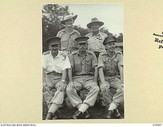 LAE, NEW GUINEA. 1944-08-03. OFFICERS OF HEADQUARTERS, 8TH SALVAGE DEPOT AND LINES OF COMMUNICATION SALVAGE SECTIONS WITH THE DIRECTOR OF ARMY SALVAGE, NEW GUINEA FORCE. IDENTIFIED PERSONNEL ARE:- ..