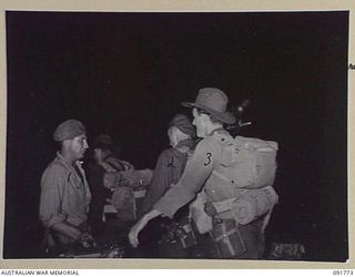 BOUGAINVILLE, 1945-05. MEMBERS OF 26 INFANTRY BATTALION (A.I.F.) AFTER A NIGHT LANDING ON TOROKORI ISLAND, EMBARKING ON BARGES. THE MEN LANDED AND PATROLLED THE ISLAND SEARCHING FOR A SUSPECTED ..