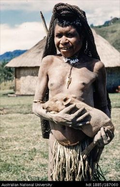 Mendi person holding a pig