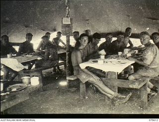 Oro Bay, New Guinea. 1943-04. Soldiers enjoy their meal in the tented Sergeants' mess at the 10th Field Ambulance, Army Medical Corps