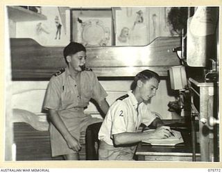 HOMBOLT BAY, NEW GUINEA. 1944-08/09. SUB-LIEUTENANT R. SLUTZKIN (1) AND LIEUTENANT R. FREWIN (2) RELAXING IN THEIR CABIN ABOARD THE RAN CORVETTE, GEELONG