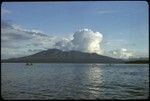 Island from a distance, and people in boats at sea