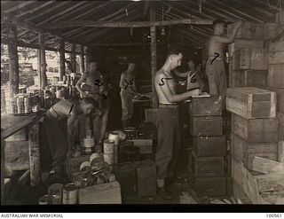 Lae, New Guinea. 1944-06-29. Personnel working in the Ration Room at HQ New Guinea Force
