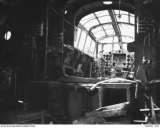 NEW BRITAIN, 1945-09. INTERIOR VIEW OF THE FUSELAGE AND COCKPIT OF A MITSUBISHI G4M "BETTY" JAPANESE BOMBER AIRCRAFT. (RNZAF OFFICIAL PHOTOGRAPH.)