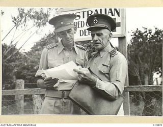 1942-12-17. NEW GUINEA. RED CROSS, MR G.F. HAUGHAN (AT LEFT) SENIOR REPRESENTATIVE FOR THE AUSTRALIAN RED CROSS, PHOTOGRAPHED WITH ASSISTANT COMMISSIONER D.H. HARDY. MR HAUGHAN HAS LIVED IN NEW ..