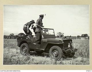 WAWIN, MARKHAM VALLEY, NEW GUINEA. 1944-10-24. NX4 BRIGADIER B.E. CLEIN, COMMANDER ROYAL ARTILLERY, IN HIS JEEP AS HE PREPARES TO INSPECT THE ROYAL AUSTRALIAN ARTILLERY UNITS OF THE 3RD DIVISION