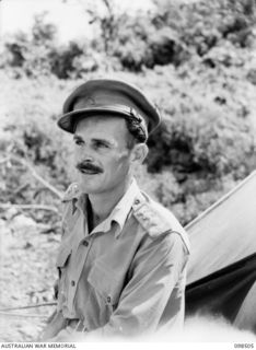 KAVIENG, NEW IRELAND. 1945-10-27. CAPTAIN F.N.W. SHAND, AUSTRALIAN NEW GUINEA ADMINISTRATIVE UNIT DISTRICT OFFICER. AN AUSTRALIAN NEW GUINEA ADMINISTRATIVE UNIT ADMINISTRATIVE HEADQUARTERS IS BEING ..