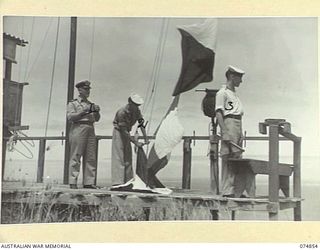 PORT MORESBY, PAPUA. 1944-07-28. RAN PERSONNEL MANNING THE SIGNAL PLATFORM AT THE RAN PORT WAR SIGNAL STATION. IDENTIFIED IS :- LIEUTNEANT A.G. STEPHEN, ROYAL AUSTRALIAN NAVY VOLUNTEER RESERVE