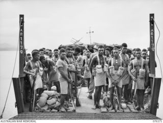 SALAMAUA, NEW GUINEA. 1944-10-01. MEMBERS OF A NEW GUINEA INFANTRY BATTALION RETURNING TO LAE AFTER AN 11 DAY JUNGLE PATROL ABOARD AN AUSTRALIAN LANDING CRAFT, AB1179 OPERATED BY THE 43RD LANDING ..