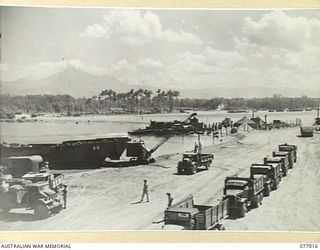 BOUGAINVILLE ISLAND, 1944-11-13. AN AMERICAN BARGE UNLOADING AT NO.4 BEACH ON THE BOUGAINVILLE PERIMETER WHICH IS CONTROLLED BY HEADQUARTERS, 3RD DIVISION