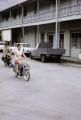 French Polynesia, people riding motorized bicycles in Papeete