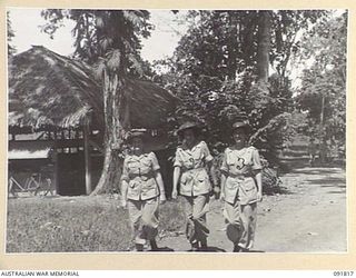 LAE, NEW GUINEA, 1945-05-15. AWAS PERSONNEL WITH INTELLIGENCE, HQ FIRST ARMY, LEAVING THEIR OFFICE TO GO TO LUNCH AT THE AWAS BARRACKS. IDENTIFIED PERSONNEL ARE:- CORPORAL I. CARTWRIGHT (1); CPL ..