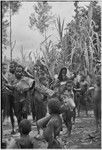 Bride price ritual: people carry pork and other exchange items, boys carry drums