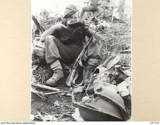 TOROKINA AREA, BOUGAINVILLE ISLAND. 1944-11-29. Q100344 PRIVATE N. CAVANAGH, D COMPANY, 9TH INFANTRY BATTALION, ENJOYING A DIXIE OF TEA AFTER A HARD MORNINGS WORK ATTACKING AND CONSOLIDATING THEIR ..