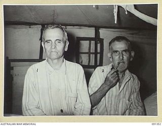 TOROKINA, BOUGAINVILLE. 1945-04-27. FATHER GRISWARD (1), AND FATHER SEILLER (2), MISSIONARIES OF THE MARIST ORDER, WHO ARE RECEIVING TREATMENT AT 2/1 GENERAL HOSPITAL FOLLOWING THEIR LIBERATION ..